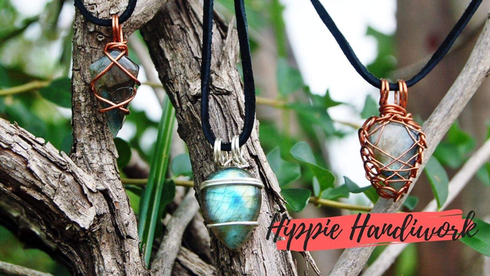 Product photo I took featuring three wire wrap pendants hanging on branches in a tree. The name of the business is shown in their logo, which I created, overlaying the image in the bottom corner.