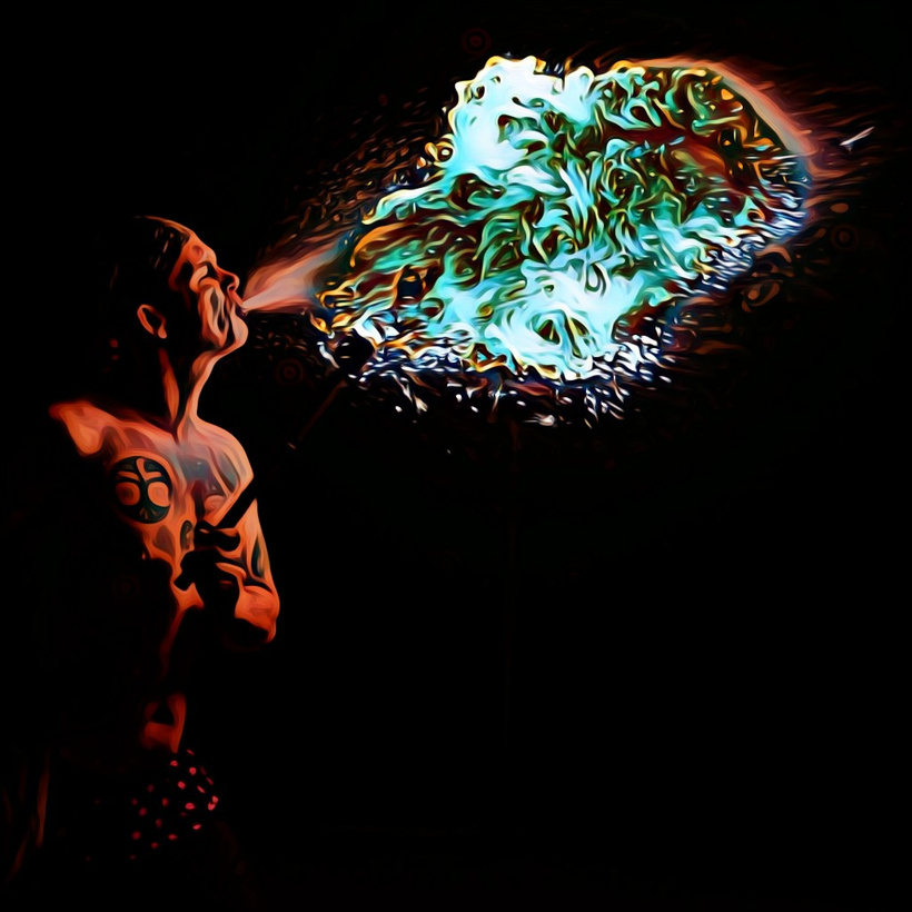Graphic, colorful digital photo edit I did of a photo that I took of a person blowing fire.  The edits make the fire green and look like swirls of paint.  